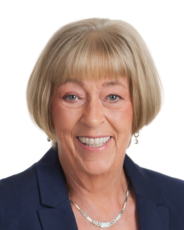 Lorna Mason — headshot, navy blazer, silver necklace